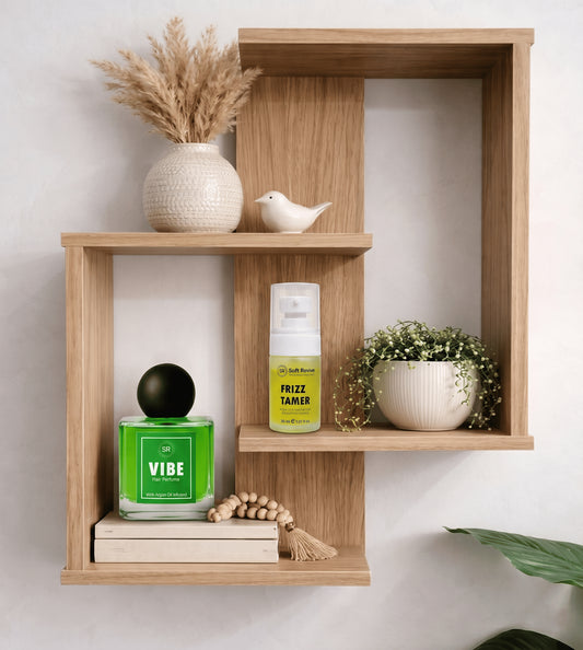 Wooden shelf with decorative items including a bottle labeled 'Vibe' and a spray bottle labeled 'Frizz Tamer'.